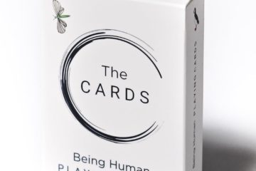 White playing card box with The Cards printed on front